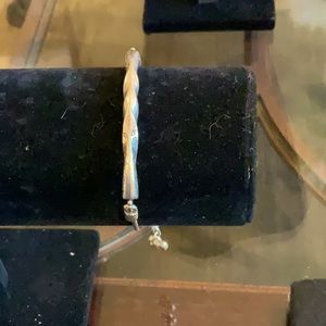 Brighton silver bracelet about 7” long. A silver bar across the top is twisted.